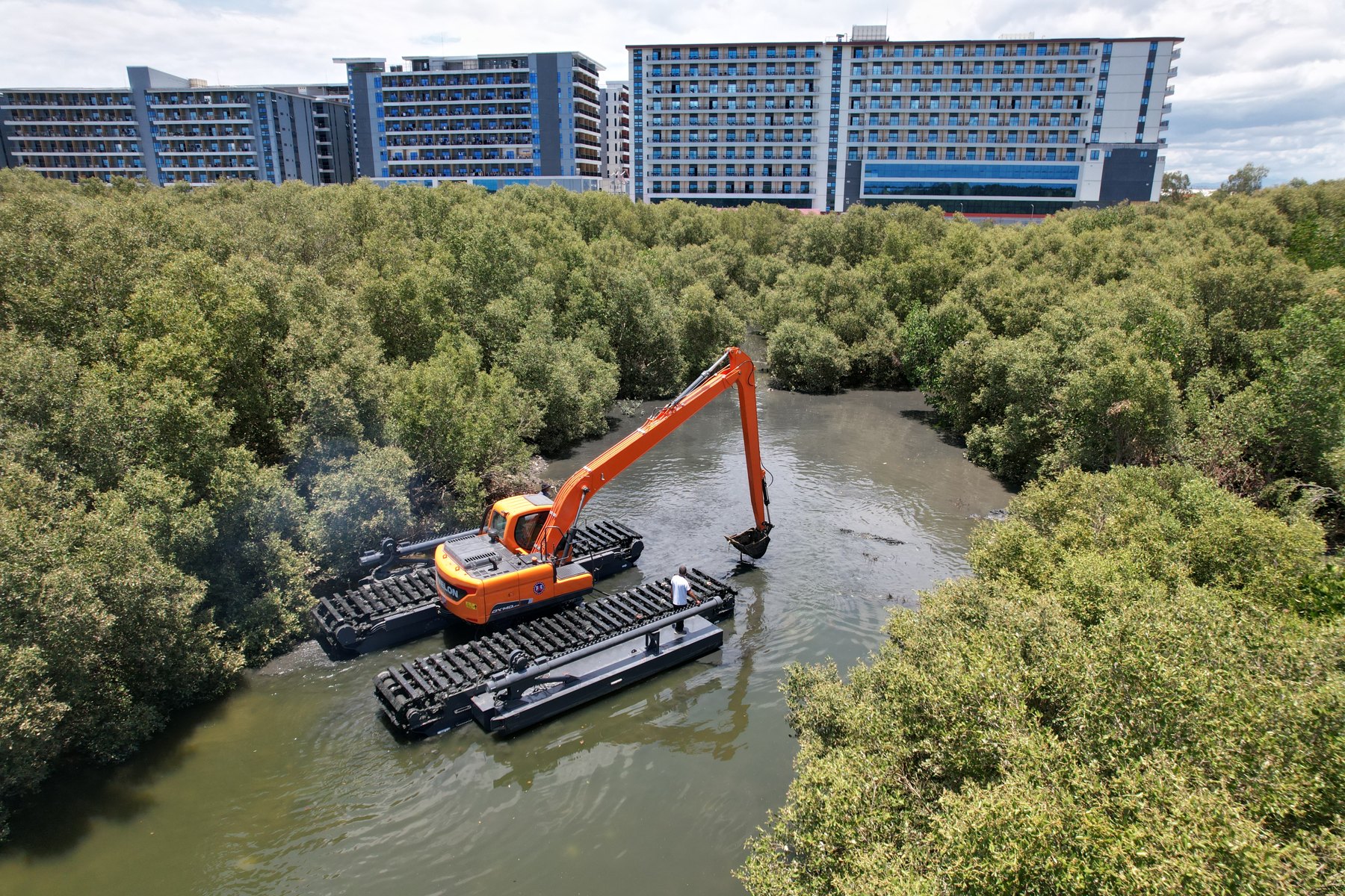 Amphibious excavator operating at project site